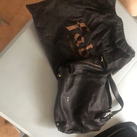 Black purse with hot pink lining by Fab. - Picture 1 of 3